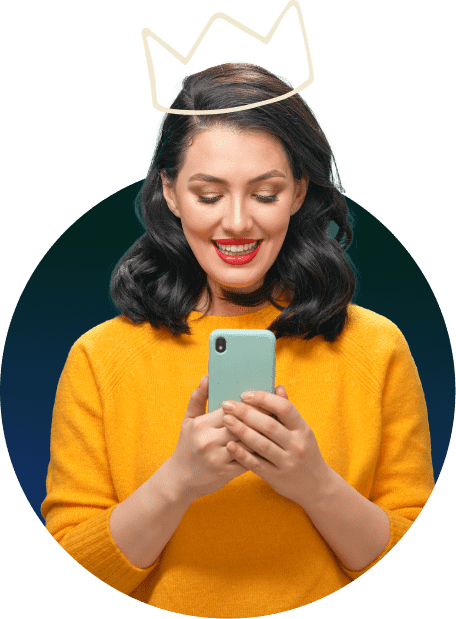 Woman smiling with her phone in her hands.
